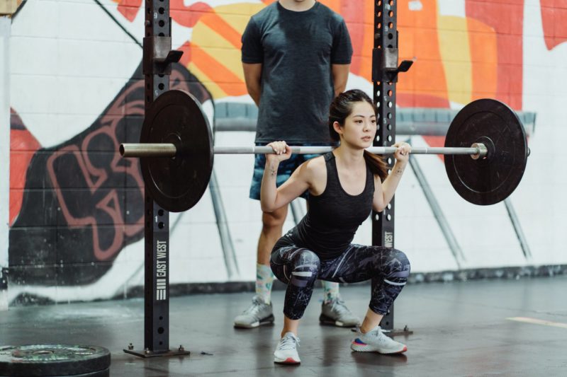 young woman lifting weights